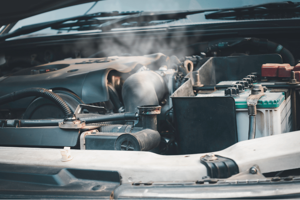 car overheating, auto repair in Arcata, CA at North Bay Automotive. Overheated engine emitting visible steam. Ideal for illustrating cooling system issues, emphasizing the importance of radiator service and engine temperature management.